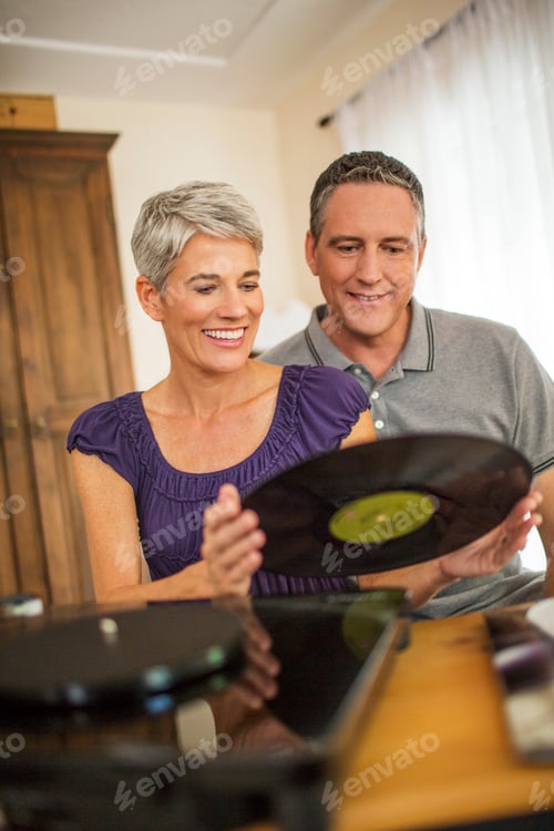 Preview: Romantic mature couple playing vinyl records