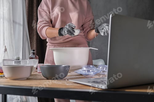 Preview: woman is taking an online lesson or watching a video on creating bath bombs.