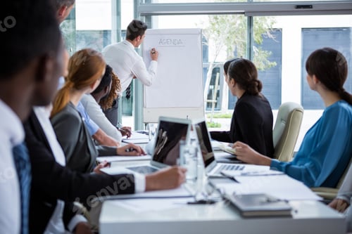 Preview: Businessman discussing on white board with coworkers