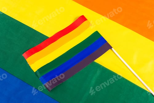 Preview: top view of small lgbt flag on rainbow colors background