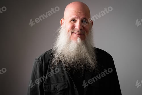 Preview: Face of happy mature handsome bald man with long beard smiling