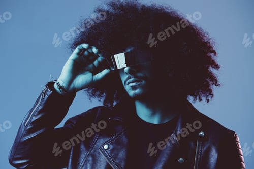 Preview: Portrait of fashion man with curly hair with stylish glasses on blue background multinational