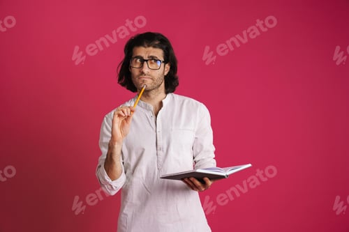 Preview: White puzzled man in eyeglasses frowning and writing down notes