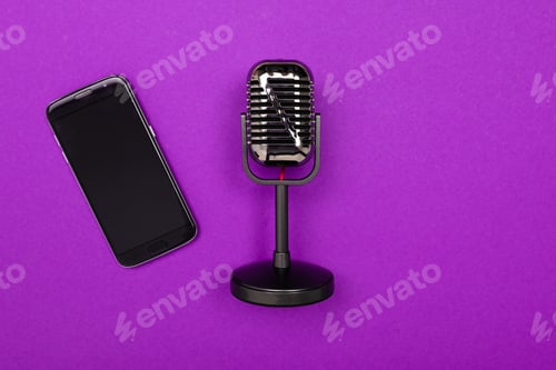 Preview: minimalism concept. phone and microphone on a bright purple background with copy space