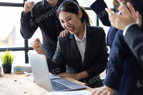 Preview: Team of business people who are excited and delighted by the success of the new project.