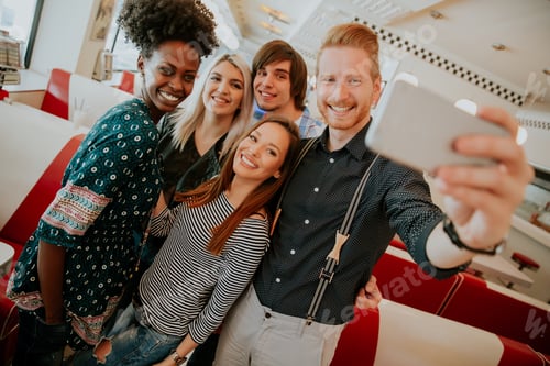 Preview: Group of young people taking selfie with mobile phone