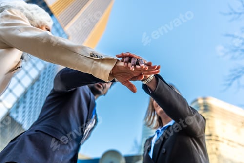 Vista previa: Business people stacking hands for teamwork and success