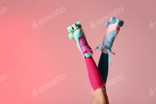Preview: Woman with vintage roller skates on color background, closeup. Space for text