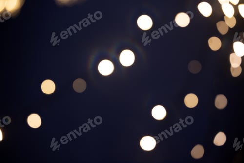 Preview: Blurred Christmas lights over dark blue background