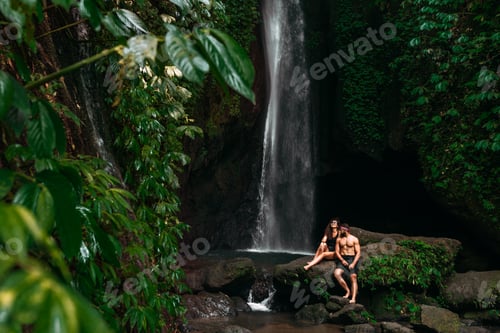 Preview: Beautiful couple at a tropical waterfall