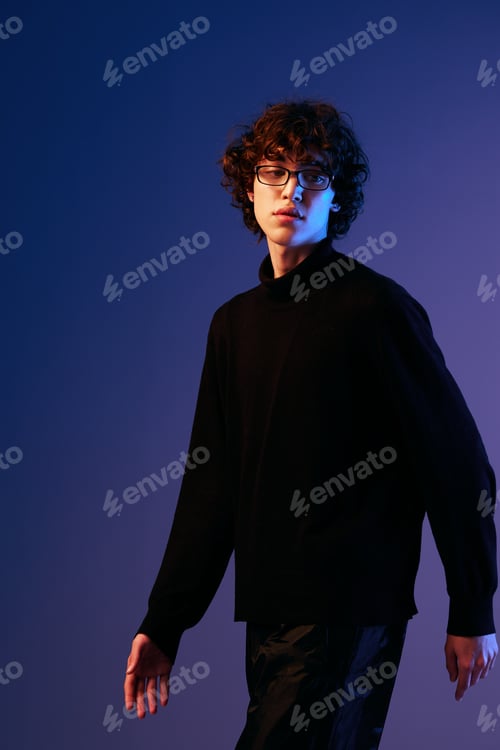 Preview: Male fashion in black model poses in glasses, hipster lifestyle, portrait blue background, mixed