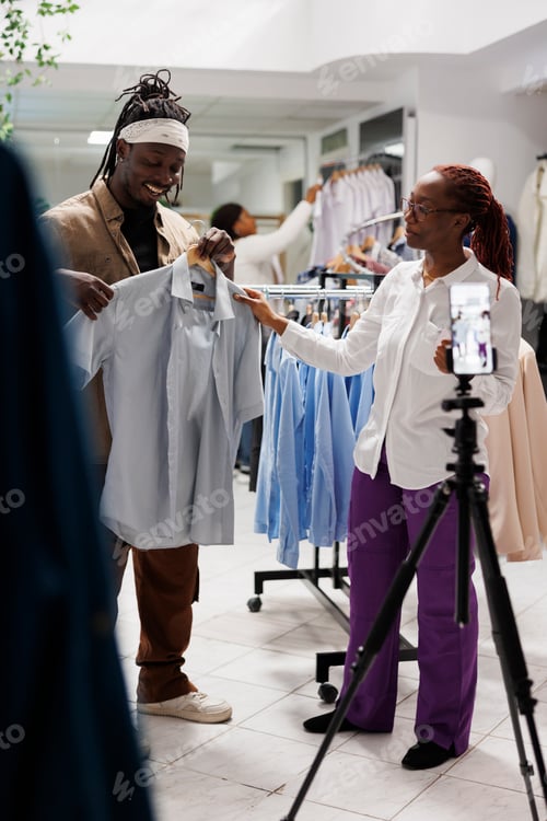 Preview: Blogger and clothing store owner showcasing shirt for promotion