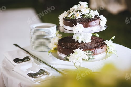 Preview: Wedding chocolate celebration cake on the table decoration with white flowers