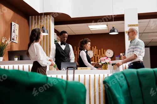 Preview: Hotel staff help elderly couple check-in