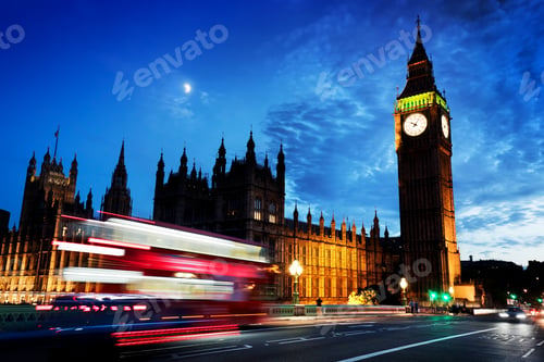 Preview: Red bus, Big Ben and Westminster Palace in London, the UK. at night. Moon shining