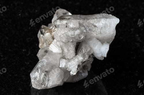 Preview: rough druse of clear quartz crystals on black