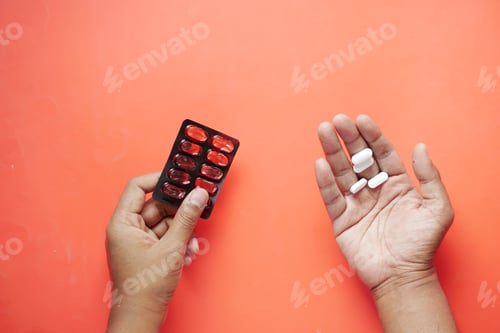 Preview: Close up of hand holding blister packs .
