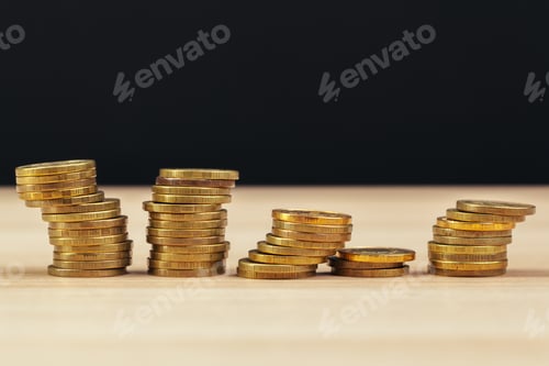 Preview: Stacks of Coins on a Wooden Table