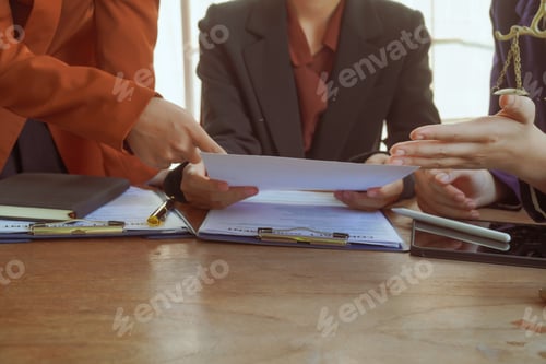 Preview: A group of lawyers and clients engage in a professional meeting law office, discussing agreements