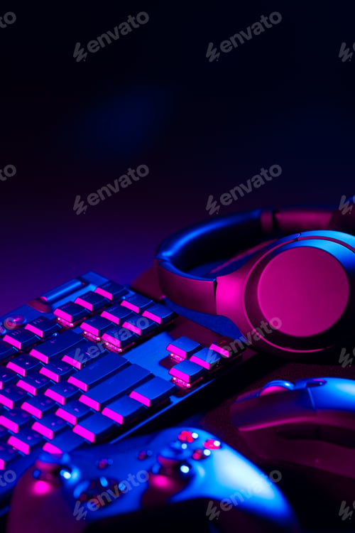 Preview: Headphones, joystick and computer keyboard on black table