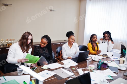 Preview: Multiracial young creative people in modern office