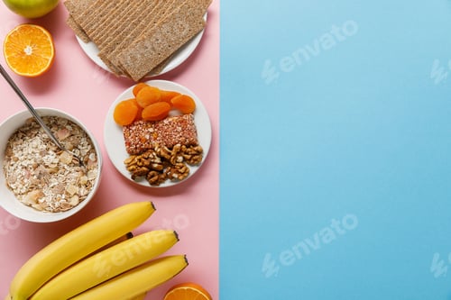 Preview: top view of fresh fruits, crispbread and breakfast cereal on blue and pink background with copy