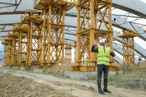 Preview: Young male builder in hardhat, formalwear and vr headset