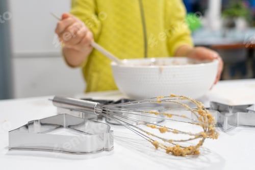 Preview: Child mixing the ingredients for some homemade cookies in a bowl