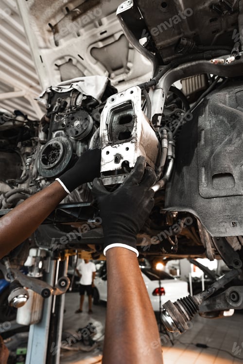Preview: Close up of hands of auto mechanic working in a garage