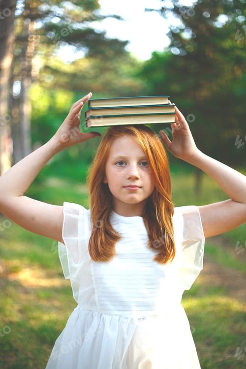 Preview: red-haired girl in a white dress with books on her head