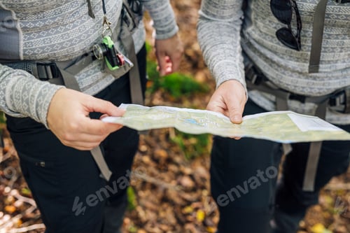 Preview: Close-up of two hikers holding map