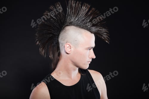 Preview: Punk Man With Mohawk Haircut. Black Shirt. Expressive Face. Isolated On Black Background. Studio