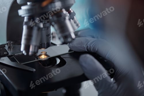 Preview: Scientist Adjusting Microscope for Detailed Observation