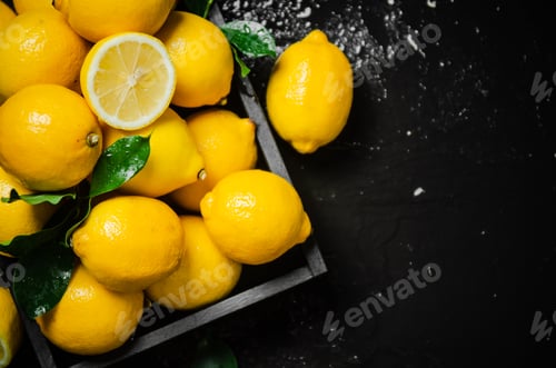 Preview: Fresh lemons. On black table.