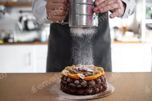 Preview: Powdered sugar sprinkled on pastry. Cooking in bakery. Cooking Cake Food at Modern Home Cuisine. Del