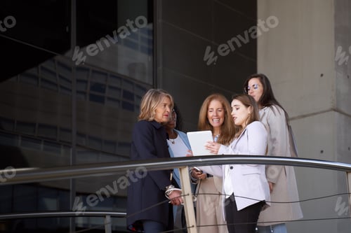 Preview: Outdoor Businesswomen Reviewing Stats on Tablet