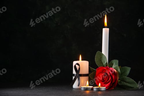 Preview: front view of burning candles with red flower on dark background evil funeral death