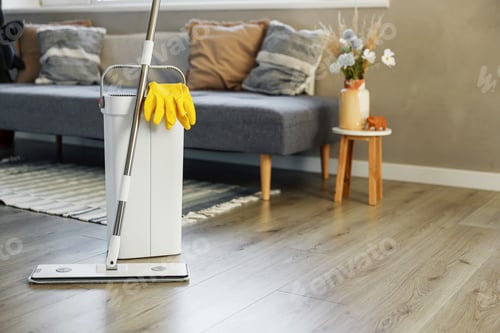 Preview: Cleaning supplies: mop, gloves, bucket with wringer on wooden laminate floor
