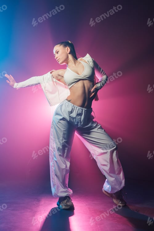 Preview: Neon urban dancer reaching pose in blue and magenta studio smoke
