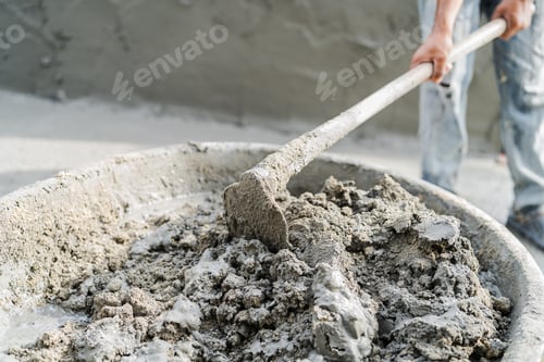 Preview: Hand worker mixed cement concrete at construction site with hoe tool, Material for plaster wall or f