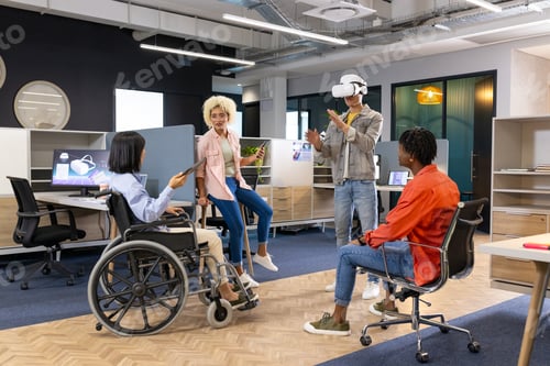 Preview: Business team from diverse backgrounds use VR and smartphones for startup business