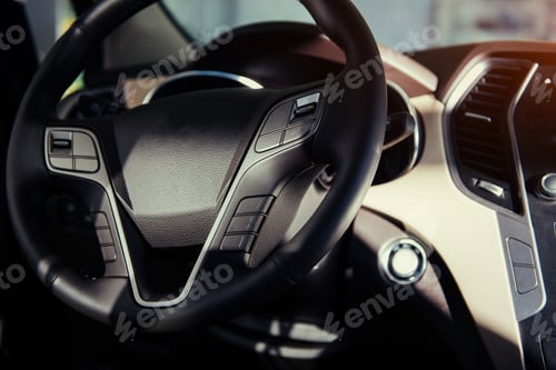 Preview: Modern car interior dashboard and steering wheel.