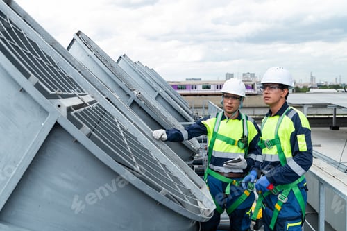 Preview: Engineers inspecting HVAC cooling systems on rooftop