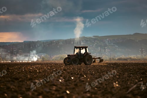Preview: Tractors plowing fields in early spring