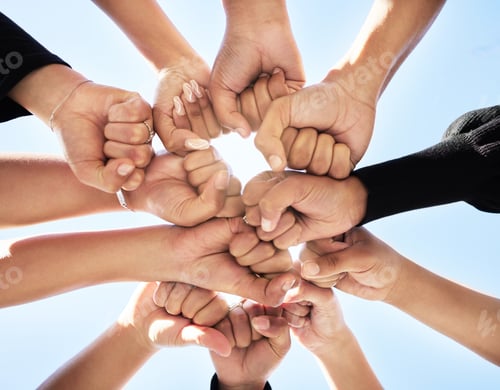 Preview: Higher power. Shot of a group of people fist bumping one another in a circle.