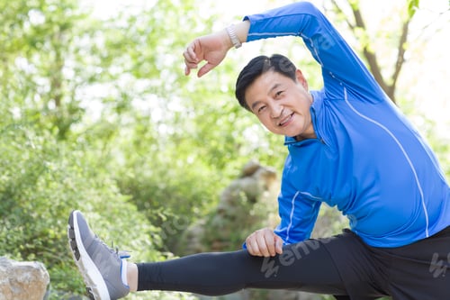 Preview: Happy mature man exercising in park