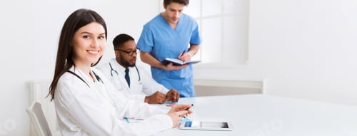 Preview: Medical conference. Practitioner at meeting looking at camera