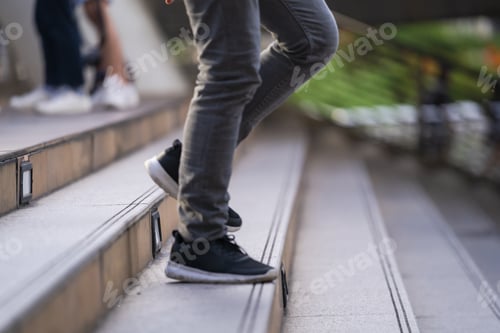 Preview: Close up of legs and shoes walking on street in the city