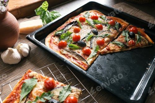 Preview: Homemade pizza with egg-plant, cherry tomatoes, cheese, olives and rocket