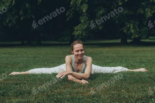 Preview: young woman athlete in sportswear practices yoga, enjoys training